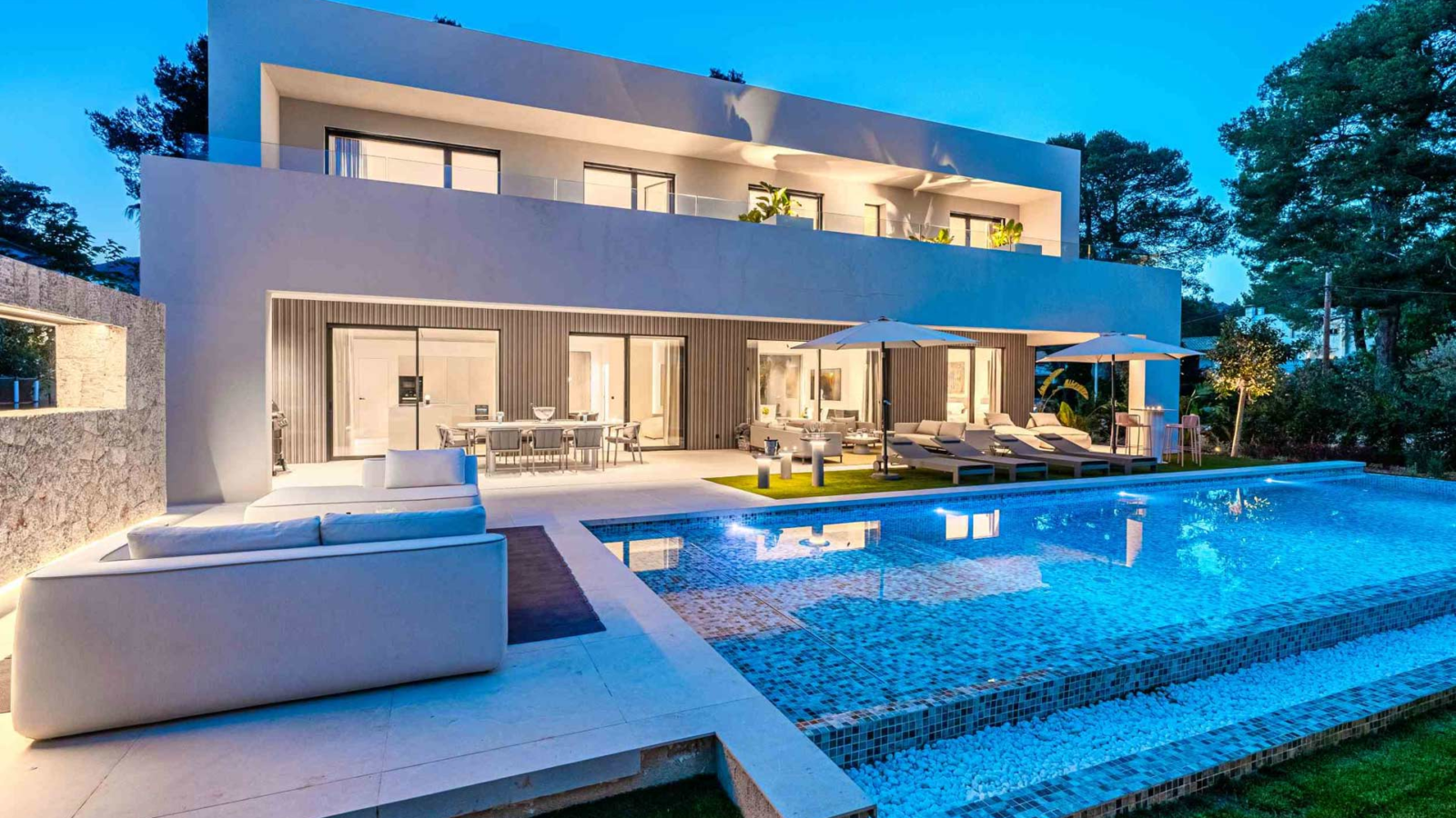 Gotmar Beach villa private pool, terrace and lounge area at dusk in Puerto Pollensa